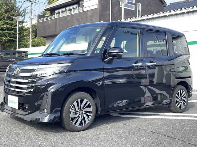 トヨタ ルーミー カスタムG 東京都 2024(令6)年 0.8万km ブラックマイカメタリック ワンオーナー/純正9インチフルセグTVディスプレイオーディオ/(Bluetooth/USB/iPod)/純正14インチアルミホイール/両側パワースライドドア/追従型クルーズコントロール/アイドリングストップ/横滑り防止装置/オートライト/スマートキー/スペアキー1本/取説書/保証書