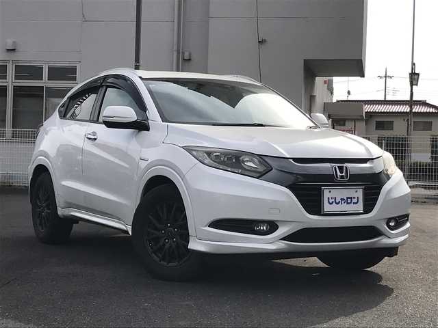 ホンダ ヴェゼル ハイブリッド Z 千葉県 2015(平27)年 14.4万km ホワイトオーキッドパール (株)IDOMが運営する【じしゃロン柏店】の自社ローン対象車両になります。こちらは現金ご利用時の価格です。/自社ローンご希望の方は別途その旨お申付け下さい。//禁煙車/純正フルセグナビ/（CD/DVD/AM/FMラジオ）/(Bluetooth)/スマートキー/プッシュスタート/バックカメラ/ＥＴＣ/クルーズコントロール/シティブレーキアクティブシステム/ルーフレール/シートヒーター/チップアップシート/ステアリングリモコン/電動格納ドアミラー/パワーウインドウ/オートライト/自動防眩ミラー