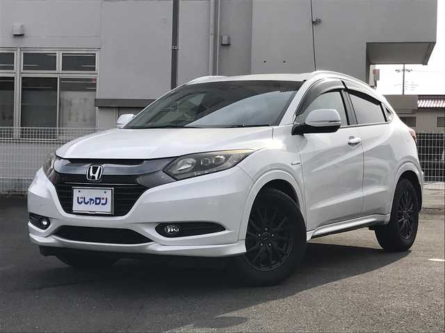 ホンダ ヴェゼル ハイブリッド Z 千葉県 2015(平27)年 14.4万km ホワイトオーキッドパール (株)IDOMが運営する【じしゃロン柏店】の自社ローン対象車両になります。こちらは現金ご利用時の価格です。/自社ローンご希望の方は別途その旨お申付け下さい。//禁煙車/純正フルセグナビ/（CD/DVD/AM/FMラジオ）/(Bluetooth)/スマートキー/プッシュスタート/バックカメラ/ＥＴＣ/クルーズコントロール/シティブレーキアクティブシステム/ルーフレール/シートヒーター/チップアップシート/ステアリングリモコン/電動格納ドアミラー/パワーウインドウ/オートライト/自動防眩ミラー