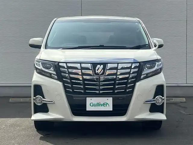 トヨタ アルファード S サイドリフトアップ 秋田県 2015(平27)年 12.8万km ラグジュアリーホワイトパールクリスタルシャインガラスフレーク ４WD/LEDヘッドライト/両側パワスラ/純正ナビ/フルセグ/バックカメラ/社外アルミ/スマートキー/アイドリングストップ/コーナーセンサー/プッシュスタート/パーキングアシスト/MTモード付AT/ステアリングスイッチ/純正エンジンスターター/ETC/純正フロアマット/純正ドアバイザー/オートライト/ダブルオートエアコン/パワーステアリング/パワーウィンドウ/寒冷地仕様/横滑り防止/電動格納ウィンカーミラー/保証書/取扱説明書/記録簿
