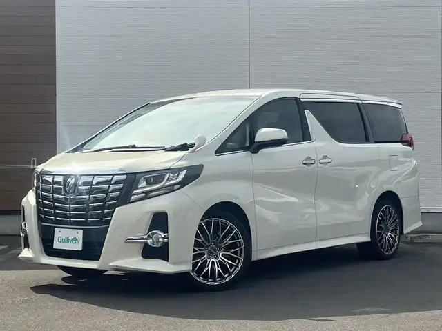 トヨタ アルファード S サイドリフトアップ 秋田県 2015(平27)年 12.8万km ラグジュアリーホワイトパールクリスタルシャインガラスフレーク ４WD/LEDヘッドライト/両側パワスラ/純正ナビ/フルセグ/バックカメラ/社外アルミ/スマートキー/アイドリングストップ/コーナーセンサー/プッシュスタート/パーキングアシスト/MTモード付AT/ステアリングスイッチ/純正エンジンスターター/ETC/純正フロアマット/純正ドアバイザー/オートライト/ダブルオートエアコン/パワーステアリング/パワーウィンドウ/寒冷地仕様/横滑り防止/電動格納ウィンカーミラー/保証書/取扱説明書/記録簿