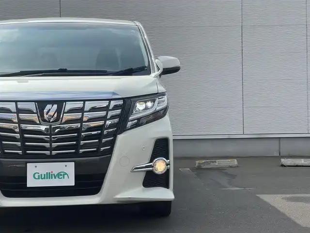 トヨタ アルファード S サイドリフトアップ 秋田県 2015(平27)年 12.8万km ラグジュアリーホワイトパールクリスタルシャインガラスフレーク ４WD/LEDヘッドライト/両側パワスラ/純正ナビ/フルセグ/バックカメラ/社外アルミ/スマートキー/アイドリングストップ/コーナーセンサー/プッシュスタート/パーキングアシスト/MTモード付AT/ステアリングスイッチ/純正エンジンスターター/ETC/純正フロアマット/純正ドアバイザー/オートライト/ダブルオートエアコン/パワーステアリング/パワーウィンドウ/寒冷地仕様/横滑り防止/電動格納ウィンカーミラー/保証書/取扱説明書/記録簿