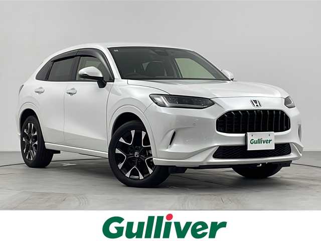 ホンダ ＺＲ－Ｖ ハイブリッド e:HEV Z 愛知県 2024(令6)年 0.3万km プラチナホワイトパール 純正9インチナビ/マルチビューカメラシステム/フルセグTV・Bluetooth/BOSEサウンド/ワイヤレス充電器/ETC2.0/本革シート/運転席助手席パワーシート/運転席助手席シートヒーター/ハンズフリーアクセステールゲート/純正18インチアルミホイール/ホンダセンシング/衝突軽減ブレーキ/先行車発進お知らせ/歩行者事故低減ステアリング/路外逸脱抑制/標識認識/渋滞追従機能付アダプティブクルーズコントロール/車線維持支援システム/トラフィックジャムアシスト(渋滞運転支援)/ブラインドスポットインフォメーション/後退出庫サポート/ヒルディセントコントロール/アダプティブドライビングビーム/LEDヘッドライト/オートライト/革巻きステアリング/パドルシフト/スマートキー/プッシュスタート/スペアキー/保証書・取扱説明書