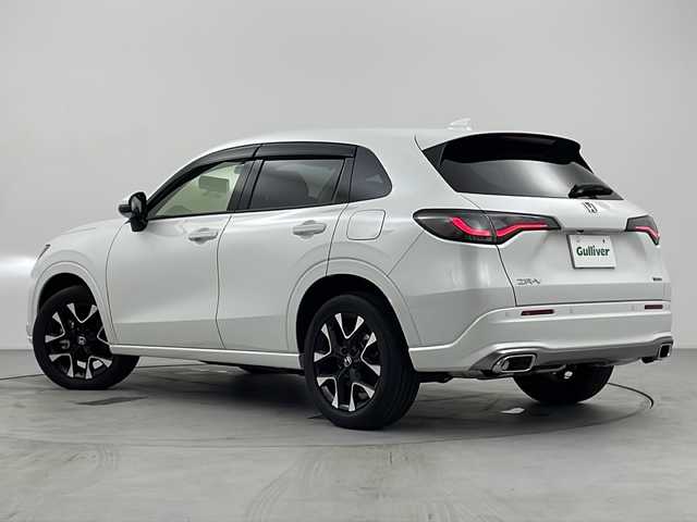 ホンダ ＺＲ－Ｖ ハイブリッド e:HEV Z 愛知県 2024(令6)年 0.3万km プラチナホワイトパール 純正9インチナビ/マルチビューカメラシステム/フルセグTV・Bluetooth/BOSEサウンド/ワイヤレス充電器/ETC2.0/本革シート/運転席助手席パワーシート/運転席助手席シートヒーター/ハンズフリーアクセステールゲート/純正18インチアルミホイール/ホンダセンシング/衝突軽減ブレーキ/先行車発進お知らせ/歩行者事故低減ステアリング/路外逸脱抑制/標識認識/渋滞追従機能付アダプティブクルーズコントロール/車線維持支援システム/トラフィックジャムアシスト(渋滞運転支援)/ブラインドスポットインフォメーション/後退出庫サポート/ヒルディセントコントロール/アダプティブドライビングビーム/LEDヘッドライト/オートライト/革巻きステアリング/パドルシフト/スマートキー/プッシュスタート/スペアキー/保証書・取扱説明書