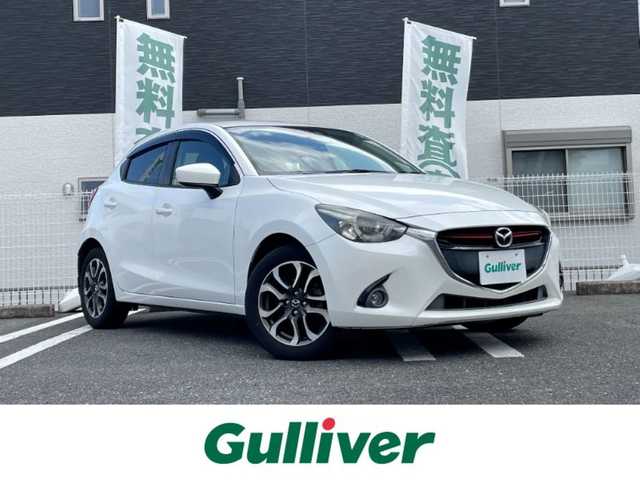 マツダ デミオ XD ツーリング 三重県 2016(平28)年 9万km スノーフレイクホワイトパールマイカ 登録時89478km/禁煙車/純正メーカーオプションナビ/・フルセグ・Ｂｌｕｅｔｏｏｔｈ・CD/DVD・AUX/・USB・SD・AM/FM/クルーズコントロール/前席シートヒーター/バックカメラ/パドルシフト/バックカメラ/衝突軽減ブレーキ/ビルドインＥＴＣ/ターボ/軽油/純正１６インチアルミホイール/HUD/簡易MTモード付ATシフト/アイドリングストップ/LEDヘッドライト/純正フロアマット