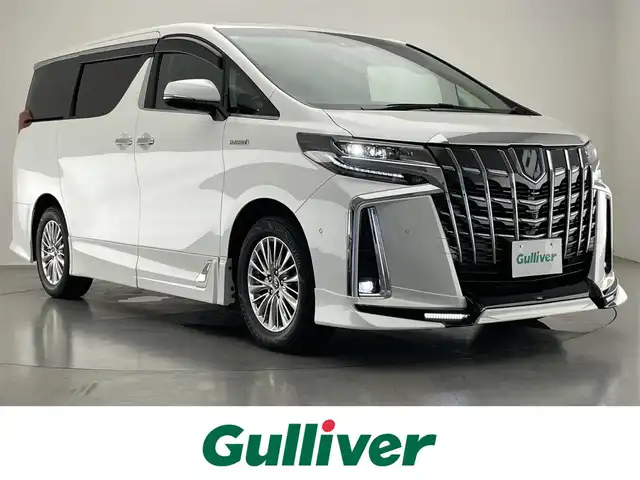 トヨタ アルファードハイブリット SR Cパッケージ 愛知県 2021(令3)年 4.8万km ホワイトパールクリスタルシャイン 純１０型ＤＡナビ　フルセグＴＶ　全方位カメラ　ＴＲＤエアロ　ＪＢＬサウンド　ツインムーンルーフ　純１３型後席モニター　ベンチレーション　黒革　３眼ＬＥＤヘッドライト　電動リアゲート　ＥＴＣ２．０　禁煙　トヨタセーフティセンス　衝突軽減　オートハイビーム　BSM　シートヒーター　/ユーザー買取/TRDフルエアロ/SR/JBL/フリップダウン/イルミ加工/パワーバックドア自動加工/両側Pスライド/プリクラッシュ/3眼LED/シーケンシャル/純正メモリナビ/全周囲カメラ/スペアキー/シートH/ベンチレーション/プリクラッシュ/記録簿