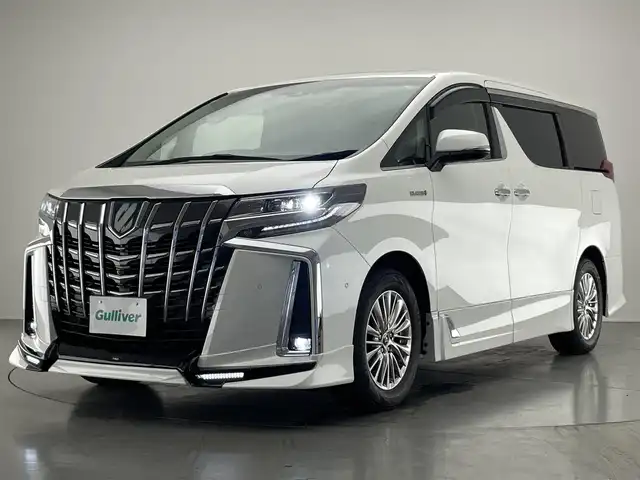 トヨタ アルファードハイブリット SR Cパッケージ 愛知県 2021(令3)年 4.8万km ホワイトパールクリスタルシャイン 純１０型ＤＡナビ　フルセグＴＶ　全方位カメラ　ＴＲＤエアロ　ＪＢＬサウンド　ツインムーンルーフ　純１３型後席モニター　ベンチレーション　黒革　３眼ＬＥＤヘッドライト　電動リアゲート　ＥＴＣ２．０　禁煙　トヨタセーフティセンス　衝突軽減　オートハイビーム　BSM　シートヒーター　/ユーザー買取/TRDフルエアロ/SR/JBL/フリップダウン/イルミ加工/パワーバックドア自動加工/両側Pスライド/プリクラッシュ/3眼LED/シーケンシャル/純正メモリナビ/全周囲カメラ/スペアキー/シートH/ベンチレーション/プリクラッシュ/記録簿