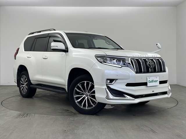 トヨタ ランドクルーザー プラド TX Lパッケージ 兵庫県 2020(令2)年 2.3万km ホワイトパールクリスタルシャイン ・モデリスタエアロ/・プリクラッシュセーフティ/・レーンディパーチャーアラート/・オートマチックハイビーム/・レーダークルーズコントロール（ブレーキ制御付）/・クリアランスソナー &バックソナー/・LEDヘッドランプ［ハイ・ロービーム］/・オートレベリング機能付/・LEDクリアランスランプ（デイライト機能付）/・ヘッドランプクリーナー/・ルーフレール/・純正9型ナビ＆TV＆BT＆DVD＆HDMI＆CD/・バックカメラ/・前後ドライブレコーダー/・ビルトインETC2.0/・スマートキー/・スペアキー/・プッシュスタート/・ステアリングリモコン/・黒革シート/・前席パワーシート/・前席シートヒーター/・前席シートクーラー/・フォグランプ/・オートライト/・純正フロアマット/・純正19インチアルミホイール/・横滑り防止装置
