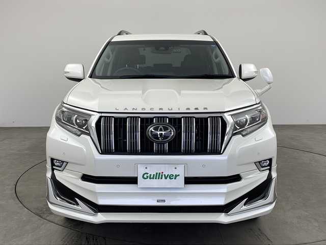 トヨタ ランドクルーザー プラド TX Lパッケージ 兵庫県 2020(令2)年 2.3万km ホワイトパールクリスタルシャイン ・モデリスタエアロ/・プリクラッシュセーフティ/・レーンディパーチャーアラート/・オートマチックハイビーム/・レーダークルーズコントロール（ブレーキ制御付）/・クリアランスソナー &バックソナー/・LEDヘッドランプ［ハイ・ロービーム］/・オートレベリング機能付/・LEDクリアランスランプ（デイライト機能付）/・ヘッドランプクリーナー/・ルーフレール/・純正9型ナビ＆TV＆BT＆DVD＆HDMI＆CD/・バックカメラ/・前後ドライブレコーダー/・ビルトインETC2.0/・スマートキー/・スペアキー/・プッシュスタート/・ステアリングリモコン/・黒革シート/・前席パワーシート/・前席シートヒーター/・前席シートクーラー/・フォグランプ/・オートライト/・純正フロアマット/・純正19インチアルミホイール/・横滑り防止装置