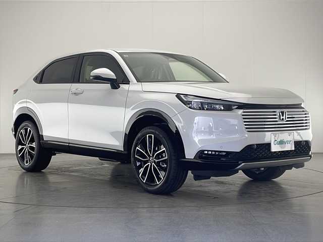 ホンダ ヴェゼル ハイブリッド e:HEV Z 宮崎県 2025(令7)年 0.1千km プラチナホワイトパール 登録済み未使用車/ホンダセンシング/純正9型ディスプレイオーディオナビTV/（Honda CONNECT/Bluetooth/FMAM/HDMI/フルセグTV)/純正ビルトイン2.0ETC/純正ワイヤレス充電器/純正LEDオートライト/純正LEDフォグ/純正18インチアルミ/アダプティブクルーズコントロール/レーンディパーチャーアラート/ダウンヒルアシストコントロール/ブラインドスポットモニター/クリアランスソナー/パワーバックドア/電子パーキング/オートホールド/パドルシフト/本革巻ハンドル/ハーフレザーシート/前席シートヒーター/ステアリングヒーター/デュアルオートエアコン/スマートキー/プッシュエンジンスタート/スペアキー/新車時保証書/取扱い説明書