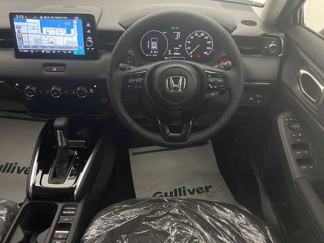 ホンダ ヴェゼル ハイブリッド e:HEV Z 宮崎県 2025(令7)年 0.1千km プラチナホワイトパール 登録済み未使用車/ホンダセンシング/純正9型ディスプレイオーディオナビTV/（Honda CONNECT/Bluetooth/FMAM/HDMI/フルセグTV)/純正ビルトイン2.0ETC/純正ワイヤレス充電器/純正LEDオートライト/純正LEDフォグ/純正18インチアルミ/アダプティブクルーズコントロール/レーンディパーチャーアラート/ダウンヒルアシストコントロール/ブラインドスポットモニター/クリアランスソナー/パワーバックドア/電子パーキング/オートホールド/パドルシフト/本革巻ハンドル/ハーフレザーシート/前席シートヒーター/ステアリングヒーター/デュアルオートエアコン/スマートキー/プッシュエンジンスタート/スペアキー/新車時保証書/取扱い説明書