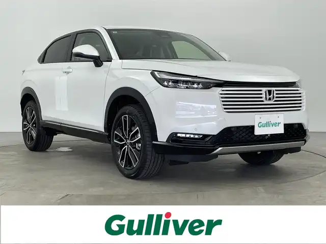 ホンダ ヴェゼル ハイブリッド e:HEV Z 大分県 2025(令7)年 0.1千km プラチナホワイトパール 純正ナビ/FM/AM/フルセグＴＶ/applecarplay/androidauto/ETC２．０/バックカメラ/シートヒーター（D/N）/ステアリングヒーター/パワーバックドア/置くだけ充電/電子パーキング/オートホールド/ホンダセンシング/・衝突軽減ブレーキ/・先行発進お知らせ機能/・コーナーセンサー/・BSM/・後方支援/オートハイビーム/パドルシフト