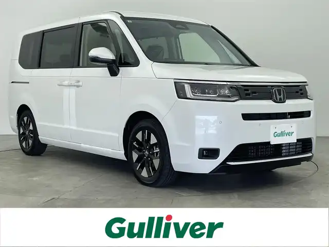 ホンダ ステップワゴン eHEV エアー EX 大分県 2025(令7)年 0.1千km プラチナホワイトパール 純正ナビ/FM/AM/フルセグＴＶ/applecarplay/androidauto/オットマン/フリップダウンモニター/バックカメラ/シートヒーター（D/N）/パワーバックドア/電子パーキング/オートホールド/ホンダセンシング/・衝突軽減ブレーキ/・先行発進お知らせ機能/・コーナーセンサー/・BSM/・後方支援/オートハイビーム/パドルシフト