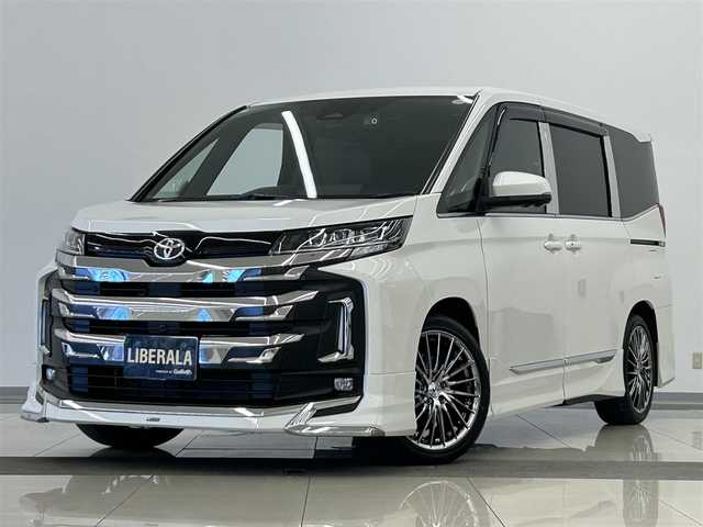 トヨタ ノア S－Z 岡山県 2025(令7)年 0.6万km ホワイトパールクリスタルシャイン トヨタ純正10.5インチナビ/アラウンドビューモニター/HDMI/USB/Bluetooth/アップルカープレイ/リアフリップダウンモニター/自動ブレーキ/LKA/BSA/ACC/ブレーキオートホールド/PTG/モデリスタフルエアロ/イルミルーフスポイラー/コーナーセンサー/社外18インチアルミ/社外フロアマット/ドアバイザー/デジタルインナーミラー/HUD/ドラレコ/CD/DVDプレイヤー/ベッドキット/釣り竿ホルダー