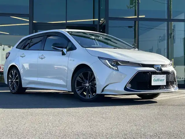 トヨタ カローラツーリング ハイブリッド ダブルバイビー 愛媛県 2020(令2)年 1.5万km ホワイトパールクリスタルシャイン 純正9型ディスプレイオーディオ/バックカメラ/前後ドライブレコーダー/トヨタセーフティセンス/レーダークルーズコントロール/ブラインドスポットモニター/クリアランスソナー/100V/1500Wコンセント/ハーフレザー/シートヒーター/ワイヤレス充電/電格ミラー/ヒートミラー/ステアリングリモコン/ステアリングヒーター/純正ドアバイザー/電動パーキングブレーキ/AutoHold機能/MODELLISTAスカッフプレート/現状サマー(純正AW)(215/45/R17)/YOKOHAMA ADVANdB V552/禁煙車