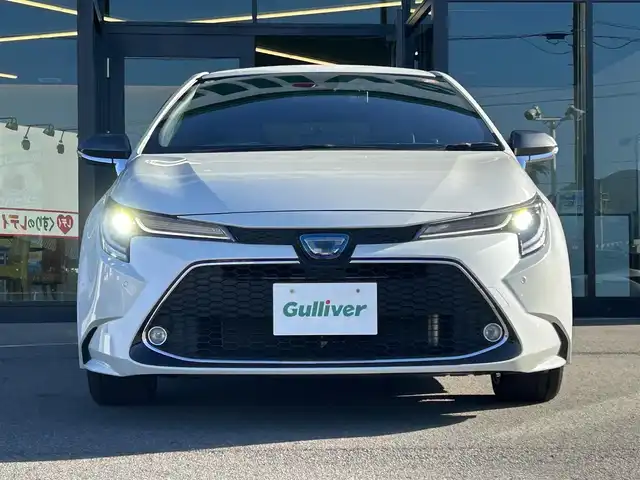 トヨタ カローラツーリング ハイブリッド ダブルバイビー 愛媛県 2020(令2)年 1.5万km ホワイトパールクリスタルシャイン 純正9型ディスプレイオーディオ/バックカメラ/前後ドライブレコーダー/トヨタセーフティセンス/レーダークルーズコントロール/ブラインドスポットモニター/クリアランスソナー/100V/1500Wコンセント/ハーフレザー/シートヒーター/ワイヤレス充電/電格ミラー/ヒートミラー/ステアリングリモコン/ステアリングヒーター/純正ドアバイザー/電動パーキングブレーキ/AutoHold機能/MODELLISTAスカッフプレート/現状サマー(純正AW)(215/45/R17)/YOKOHAMA ADVANdB V552/禁煙車