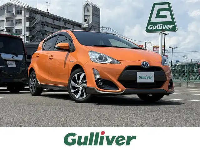 トヨタ アクア X－URBAN 大分県 2015(平27)年 7.5万km オレンジパールクリスタルシャイン 純正ＳＤナビ（NSZT-W64）/バックカメラ/ＤＴＶ/ＢＴ/ＣＤ／ＤＶＤ/純正１６インチＡＷ/シートヒーター/スマートキー/プッシュスタート/ナノイー/純正ＬＥＤヘッドライト/ステアリングスイッチ/ハーフレザー/純正フロアマット/純正サイドバイザー/ルーフレール