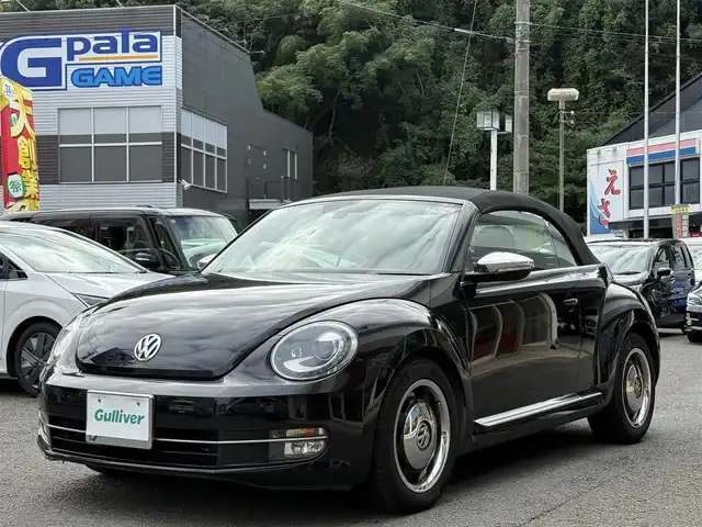 フォルクスワーゲン ザ・ビートル カブリオレ 長崎県 2014(平26)年 10.5万km 黒 登録時104120km/純正ナビ/・TV/・DVD/・Bluetooth/バックカメラ/D＋N席シートヒーター/オートヘッドライト/オープンカー/電動格納ミラー/MT付きAT