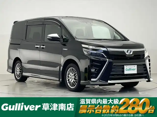 トヨタ ヴォクシー ハイブリッド ZS 煌 滋賀県 2018(平30)年 8.7万km イナズマスパーキングブラックガラスフレーク 純正9インチナビ/Bluetooth/CD/DVD/フルセグTV/フリップダウンモニター/クルーズコントロール/バックカメラ/両側電動スライドドア/シートヒーター/ステアリングリモコン/LEDヘッドライト/ドライブレコーダー/ETC