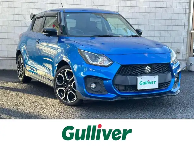スズキ スイフト スポーツ 大分県 2020(令2)年 10.5万km スピーディーブルーM 〇ワンオーナー/〇純正メモリーナビ（CN-RZ856）/　CD/DVD/BT/フルセグ/〇全方位カメラ/〇社外GReddyリアスポイラー/〇ETC/〇パドルシフト/〇ACC/〇LKA/〇フロアマット/〇ドアバイザー/〇プライバシーガラス/〇革巻きステアリング/〇前後ドライブレコーダー/〇ステアリングスイッチ/〇ウインカーミラー/〇純正LEDヘッドライト/〇純正フォグランプ/〇純正バックフォグ/〇保証書/〇取扱説明書/〇スマートキー/〇エンジンプッシュスタート
