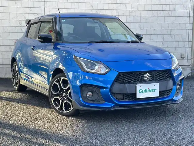 スズキ スイフト スポーツ 大分県 2020(令2)年 10.5万km スピーディーブルーM 〇ワンオーナー/〇純正メモリーナビ（CN-RZ856）/　CD/DVD/BT/フルセグ/〇全方位カメラ/〇社外GReddyリアスポイラー/〇ETC/〇パドルシフト/〇ACC/〇LKA/〇フロアマット/〇ドアバイザー/〇プライバシーガラス/〇革巻きステアリング/〇前後ドライブレコーダー/〇ステアリングスイッチ/〇ウインカーミラー/〇純正LEDヘッドライト/〇純正フォグランプ/〇純正バックフォグ/〇保証書/〇取扱説明書/〇スマートキー/〇エンジンプッシュスタート