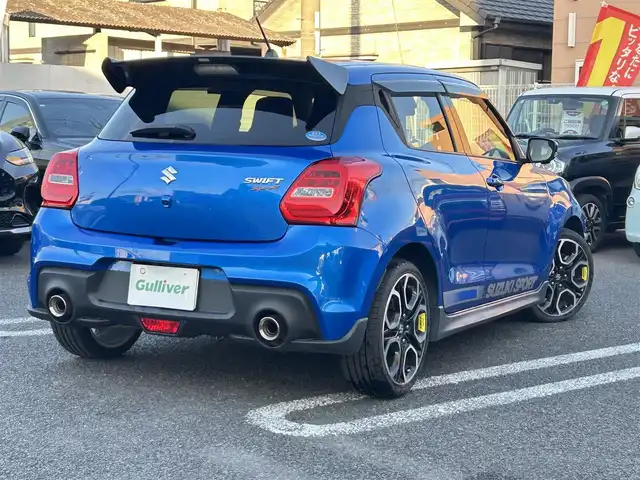 スズキ スイフト スポーツ 大分県 2020(令2)年 10.5万km スピーディーブルーM 〇ワンオーナー/〇純正メモリーナビ（CN-RZ856）/　CD/DVD/BT/フルセグ/〇全方位カメラ/〇社外GReddyリアスポイラー/〇ETC/〇パドルシフト/〇ACC/〇LKA/〇フロアマット/〇ドアバイザー/〇プライバシーガラス/〇革巻きステアリング/〇前後ドライブレコーダー/〇ステアリングスイッチ/〇ウインカーミラー/〇純正LEDヘッドライト/〇純正フォグランプ/〇純正バックフォグ/〇保証書/〇取扱説明書/〇スマートキー/〇エンジンプッシュスタート