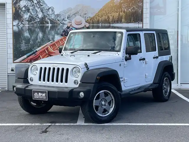 クライスラー・ジープ ジープ ラングラー アンリミテッド スポーツ 長野県 2016(平28)年 12.1万km ブライトホワイト ４WDワンオーナー/記録簿9枚（メンテナンスノート内含む）/カラーコード：PW7/積込純正ホイール・サマータイヤ4本/カロッツェリアナビ/フルセグTV/Bluetooth/バックカメラ・左側サイドカメラ/ETC/革巻きステアリング/MTモード付オートマ/クルーズコントロール/横滑り防止/リモコンキー/スペアキー/取扱説明書/保証書