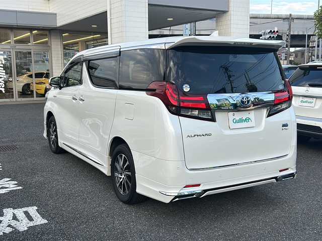 トヨタ アルファードハイブリット G Fパッケージ 東京都 2015(平27)年 7万km ホワイトパールクリスタルシャイン 純正メモリナビ/　CD/DVD/BT/フルセグテレビ/バックカメラ/全方位カメラ/フリップダウンモニター/ウィンカーミラー/オットマン/キャプテンシート/クルーズコントロール/ドアバイザー/プッシュスタート/両側パワースライドドア/パワーバックドア/ビルトインETC/LEDヘッドライト/レザーシート/D/Nシートヒーター/パワーシート/置くだけ充電/前後コーナーセンサー/JBLサウンド/モデリスタエアロ/ハンドルヒーター
