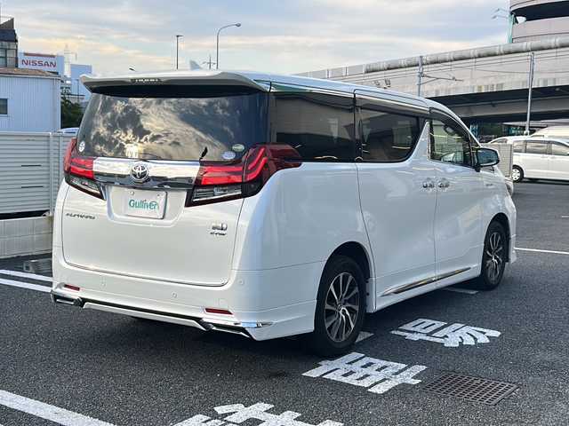トヨタ アルファードハイブリット G Fパッケージ 東京都 2015(平27)年 7万km ホワイトパールクリスタルシャイン 純正メモリナビ/　CD/DVD/BT/フルセグテレビ/バックカメラ/全方位カメラ/フリップダウンモニター/ウィンカーミラー/オットマン/キャプテンシート/クルーズコントロール/ドアバイザー/プッシュスタート/両側パワースライドドア/パワーバックドア/ビルトインETC/LEDヘッドライト/レザーシート/D/Nシートヒーター/パワーシート/置くだけ充電/前後コーナーセンサー/JBLサウンド/モデリスタエアロ/ハンドルヒーター