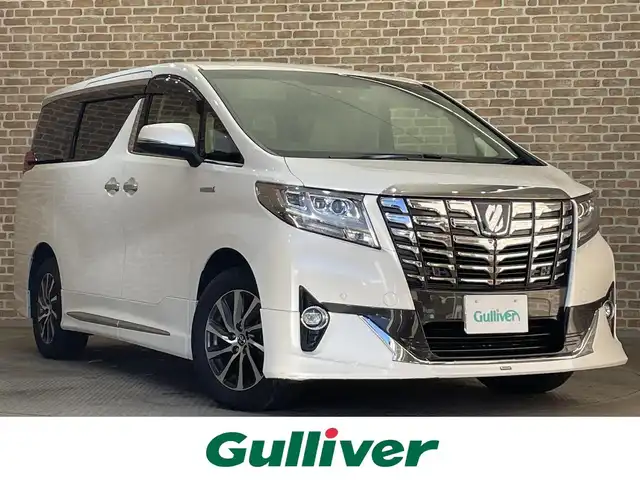 トヨタ アルファードハイブリット G Fパッケージ 岩手県 2015(平27)年 7万km ホワイトパールクリスタルシャイン 純正メモリナビ/　CD/DVD/BT/フルセグテレビ/バックカメラ/全方位カメラ/フリップダウンモニター/ウィンカーミラー/オットマン/キャプテンシート/クルーズコントロール/ドアバイザー/プッシュスタート/両側パワースライドドア/パワーバックドア/ビルトインETC/LEDヘッドライト/レザーシート/D/Nシートヒーター/パワーシート/置くだけ充電/前後コーナーセンサー/JBLサウンド/モデリスタエアロ/ハンドルヒーター