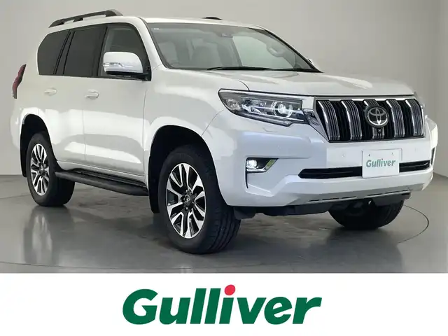 トヨタ ランドクルーザー プラド TX Lパッケージ 愛知県 2023(令5)年 2万km ホワイトパールクリスタルシャイン 純正８型ＤＡナビ　ムーンルーフ　全方位カメラ　禁煙　ＥＴＣ２．０　ベージュ革　ベンチレーション　シートヒーター　セーフティセンス　衝突軽減　追従クルコン　ＬＥＤオートライト　ＢＳＭ　ルーフレール
