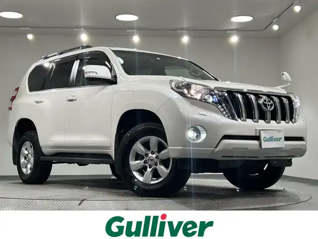 トヨタ ランドクルーザー プラド TX Lパッケージ 愛知県 2014(平26)年 6.5万km ホワイトパールクリスタルシャイン ＳＤナビ　/(Ｂｌｕｅｔｏｏｔｈ/フルセグＴＶ/SD/CD・DVD再生/iPod)/サンルーフ　/黒レザーシート　/前席シートヒーター　/ＥＴＣ　/バックカメラ　/USB接続/電動パワーシート　/クルーズコントロール　/ＬＥＤヘッドライト　　/純正フロアマット　/ＬＥＤフォグ/盗難防止装置