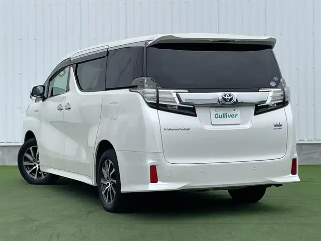 トヨタ ヴェルファイア ハイブリット ZR 香川県 2015(平27)年 8.9万km プレシャスホワイトパール 登録時走行距離：88289km/4WD/純正9インチナビ/→AM/FM/フルセグTV/Bluetooth/→CD/DVD再生/→HDMI入力/JBLプレミアムサウンドシステム/バックカメラ/クルーズコントロール/シートメモリー付きパワーシート/ハーフレザーシート/オットマン/キャプテンシート/両側パワースライドドア/パワーバックドア/LEDオートライト/フォグランプ/オートハイビーム/トヨタセーフティセンス/→プリクラッシュセーフティ/→レーンディパーチャーアラート/→クリアランスソナー/プッシュスタート/スマートキー