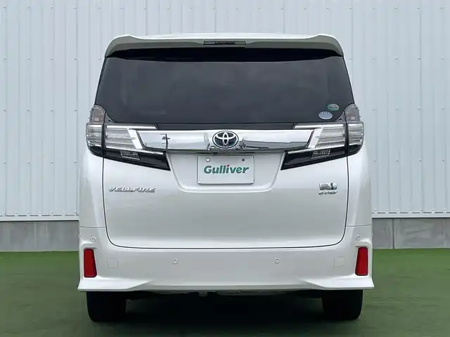 トヨタ ヴェルファイア ハイブリット ZR 香川県 2015(平27)年 8.9万km プレシャスホワイトパール 登録時走行距離：88289km/4WD/純正9インチナビ/→AM/FM/フルセグTV/Bluetooth/→CD/DVD再生/→HDMI入力/JBLプレミアムサウンドシステム/バックカメラ/クルーズコントロール/シートメモリー付きパワーシート/ハーフレザーシート/オットマン/キャプテンシート/両側パワースライドドア/パワーバックドア/LEDオートライト/フォグランプ/オートハイビーム/トヨタセーフティセンス/→プリクラッシュセーフティ/→レーンディパーチャーアラート/→クリアランスソナー/プッシュスタート/スマートキー