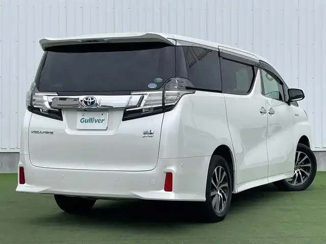トヨタ ヴェルファイア ハイブリット ZR 香川県 2015(平27)年 8.9万km プレシャスホワイトパール 登録時走行距離：88289km/4WD/純正9インチナビ/→AM/FM/フルセグTV/Bluetooth/→CD/DVD再生/→HDMI入力/JBLプレミアムサウンドシステム/バックカメラ/クルーズコントロール/シートメモリー付きパワーシート/ハーフレザーシート/オットマン/キャプテンシート/両側パワースライドドア/パワーバックドア/LEDオートライト/フォグランプ/オートハイビーム/トヨタセーフティセンス/→プリクラッシュセーフティ/→レーンディパーチャーアラート/→クリアランスソナー/プッシュスタート/スマートキー