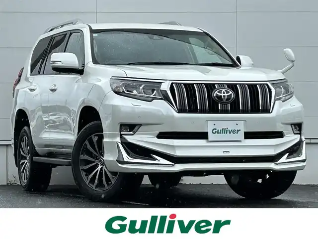 トヨタ ランドクルーザー プラド TX Lパッケージ 佐賀県 2018(平30)年 3.1万km ホワイトパールクリスタルシャイン モデリスタエアロ/ルーフレール/4WD/トヨタセーフティセンス/・プリクラッシュセーフティ/・レーンディパーチャーアラート/・レーダークルーズコントロール/・オートマチックハイビーム/クリアランスソナー/社外8インチナビ/・バックカメラ/・フルセグTV/BT/CD/DVD/ベージュ革シート/前席シートベンチレーション/前席シートヒーター/前席パワーシート/電動格納サードシート/純正19インチAW/LEDヘッドライト/フォグランプ/ETC/エアバックW/サイド/カーテン/スペアキー×１/取扱説明書/保証書