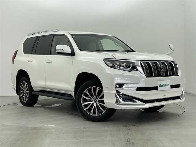 トヨタ ランドクルーザー プラド TX Lパッケージ 富山県 2018(平30)年 3.1万km ホワイトパールクリスタルシャイン モデリスタエアロ/ルーフレール/4WD/トヨタセーフティセンス/・プリクラッシュセーフティ/・レーンディパーチャーアラート/・レーダークルーズコントロール/・オートマチックハイビーム/クリアランスソナー/社外8インチナビ/・バックカメラ/・フルセグTV/BT/CD/DVD/ベージュ革シート/前席シートベンチレーション/前席シートヒーター/前席パワーシート/電動格納サードシート/純正19インチAW/LEDヘッドライト/フォグランプ/ETC/エアバックW/サイド/カーテン/スペアキー×１/取扱説明書/保証書