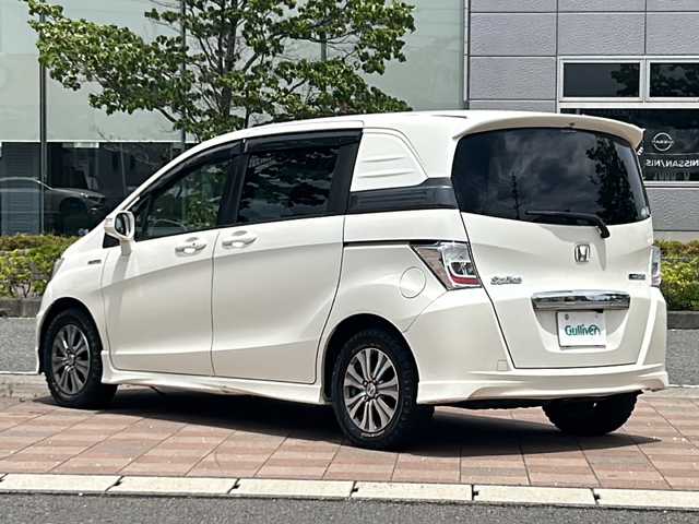 ホンダ フリード スパイク ハイブリット ジャストセレクション 福島県 2012(平24)年 11.7万km プレミアムホワイトパール 純正ナビゲーション/型番：VXM-135VFN/【CD/DVD/SD/TV】/フリップダウンモニター/型番：VM-108N/バックカメラ/ETC/両側電動スライドドア/オートライト/ステアリングリモコン/シートバックテーブル/純正フロアマット/ドアバイザー