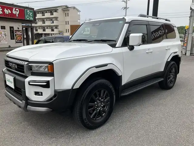 トヨタ ランドクルーザー ２５０ VX 滋賀県 2024(令6)年 0.2万km プラチナホワイトパールマイカ ワンオーナー/令和9年10月まで/モデリスタエアロ/フロントバンパーガード/リアバンパーガーニッシュ/オーバーフェンダー/リアスポイラー/トヨタセーティセンス/ブラインドスポットモニター/パーキングサポートブレーキ/12.3インチディスプレイオーディオ/パノラミックビューモニター/ETC2.0/デジタルインナーミラー/サンルーフ/ブラックレザーシート/パワーシート、シートヒーター/パワーバックドア/スペアキー有り/取扱説明書、保証書/