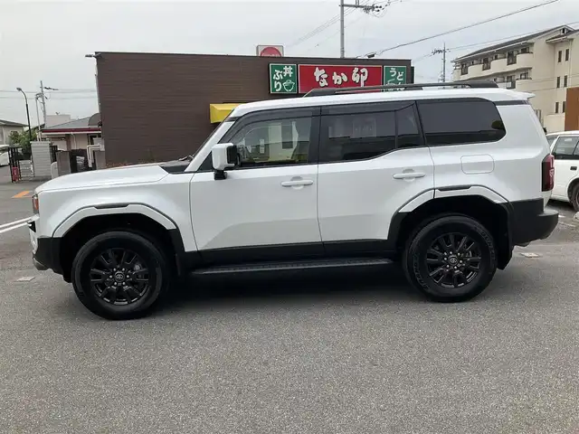 トヨタ ランドクルーザー ２５０ VX 滋賀県 2024(令6)年 0.2万km プラチナホワイトパールマイカ ワンオーナー/令和9年10月まで/モデリスタエアロ/フロントバンパーガード/リアバンパーガーニッシュ/オーバーフェンダー/リアスポイラー/トヨタセーティセンス/ブラインドスポットモニター/パーキングサポートブレーキ/12.3インチディスプレイオーディオ/パノラミックビューモニター/ETC2.0/デジタルインナーミラー/サンルーフ/ブラックレザーシート/パワーシート、シートヒーター/パワーバックドア/スペアキー有り/取扱説明書、保証書/