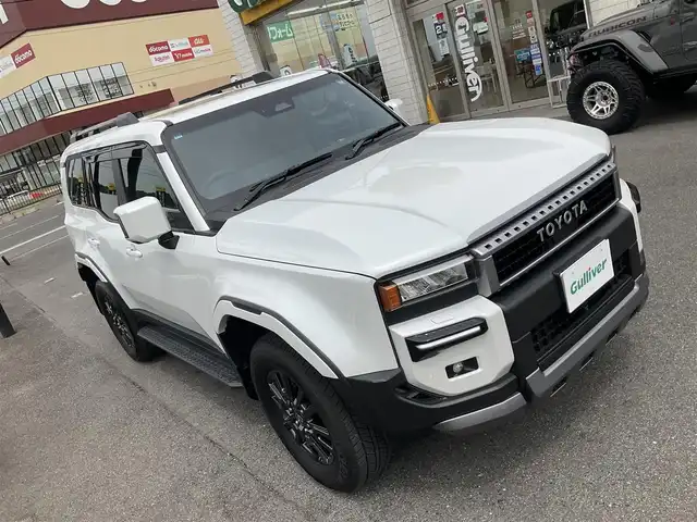 トヨタ ランドクルーザー ２５０ VX 滋賀県 2024(令6)年 0.2万km プラチナホワイトパールマイカ ワンオーナー/令和9年10月まで/モデリスタエアロ/フロントバンパーガード/リアバンパーガーニッシュ/オーバーフェンダー/リアスポイラー/トヨタセーティセンス/ブラインドスポットモニター/パーキングサポートブレーキ/12.3インチディスプレイオーディオ/パノラミックビューモニター/ETC2.0/デジタルインナーミラー/サンルーフ/ブラックレザーシート/パワーシート、シートヒーター/パワーバックドア/スペアキー有り/取扱説明書、保証書/