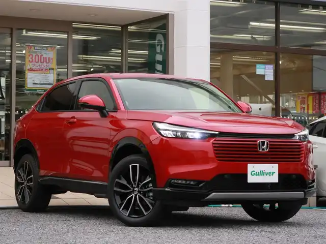 ホンダ ヴェゼル ハイブリッド e:HEV Z 千葉県 2025(令7)年 0.1千km プレミアムクリスタルレッドM 登録済未使用車/ホンダコネクトディスプレイ/ナビゲーション/フルセグTV/Bluetooth/AM/FM/USB/マルチビューカメラ/ホンダセンシング/BSI/ブラインドスポットインフォメーション/ハンズフリーアクセスパワーテールゲート/シートヒーター/ステアリングヒーター/ビルトインETC2.0/ハーフレザー/プレミアムオーディオ/純正18インチAW/レーダークルーズコントロール/パドルシフト/ワイヤレス充電/LEDヘッドライト/LEDフォグランプ/USB充電/スマートキー×2本/取説/保証書