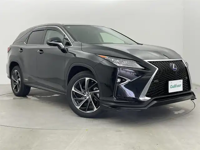 レクサス ＲＸ 450hL 富山県 2018(平30)年 6.5万km グラファイトブラックガラスフレーク 純正ナビ（AM/FM/CD/DVD/BD/AUX/USB/BT）/フルセグTV/パノラミックビューモニター/Fスポーツグリル/TRDフロントエアロ/サンルーフ/プリクラッシュセーフティ/レーンキーピングアシスト/オートマチックハイビーム/レーダークルーズコントロール/ブラインドスポットモニター/クリアランスソナー/ヘッドアップディスプレイ/本革シート（ノーブルブラウン）/1列目メモリ付きシート/パワーシート/1/2列目シートヒーター/1列目エアシート/電動格納サードシート/ステアリングヒーター/純正20インチAW/3眼LEDヘッドライト/LEDフォグランプ/シーケンシャルランプ/置くだけ充電/100V充電/デジタルインナーミラー/ドライブレコーダー前後/ビルトインETC2.0/パドルシフト/オートブレーキホールド/電動パーキングブレーキ/純正フロアマット/スペアキー/カードキーあり/プッシュスタート/取扱説明書/保証書