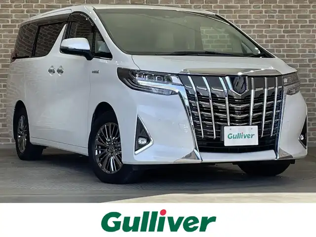 トヨタ アルファードハイブリット エグゼクティブ ラウンジ 岩手県 2021(令3)年 2.4万km ホワイトパールクリスタルシャイン ４WD/電動サイドステップ/ツインムーンルーフ/パノラミックビューモニター/インテリジェントパーキングアシスト/JBLプレミアムサウンドシステム/プレミアムナッパ本革シート/13.3インチリヤエンターテインメントシステム/置くだけ充電/デジタルインナーミラー/三眼LEDヘッドランプ/AC100V1500Wアクセサリーコンセント/パワーバックドア/両側パワースライドドア/エグゼグティブラウンジシート/トヨタセーフティセンス/プリクラッシュセーフティ/レーダークルーズコントロール/レーントレーシングアシスト/アダプティブハイビームシステム/クリアランスソナー/RCTA・BSM/パワーシート/シートヒーター/シートベンチレーション/ステアリングヒーター/10.5インチT-ConnectSDナビ/(フルセグTV・CD・DVD・Blu-rayDisc・Bluetooth・ミラキャスト・AppleCarPlay・AndroidAuto)/ETC2.0/ドライブレコーダー/純正１７インチアルミホイール