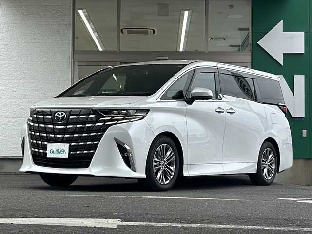 トヨタ アルファードハイブリット Z 愛知県 2024(令6)年 1.4万km プラチナホワイトパールマイカ 禁煙車/法人ワンオーナー/純正メーカーナビ、TV/パノラミックビューモニター/レザーシート/独立サンルーフ/両側パワースライドドア/トヨタチームメイト/自動駐車/ユニバーサルステップ/ヘッドアップディスプレイ/ブラインドスポットモニター/フリップダウンモニター/デジタルインナーミラー/アダプティプクルーズコントロール/レーンキープアシスト/パドルシフト/置くだけ充電/HDMI/前後コーナーセンサー/クリアランスソナー/Bluetooth/Miracast/ステアリングリモコン/ハンドルヒーター/シートヒーター（セカンドシートまで）/エアシート（セカンドシートまで）/パワーシート/メモリーシート/オットマン/後席サンシェード/AUTOHOLD/純正18アルミ/純正フロアマット/ドアバイザー/フォグランプ/LEDヘッドライト/AUTOライト/AUTOハイビーム/ETC/前後ドラレコ/スペアキー/取扱説明書/保証書