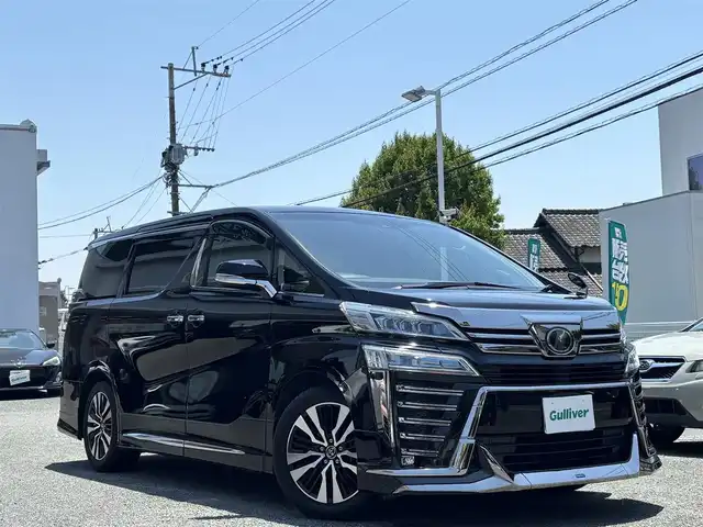 トヨタ ヴェルファイア Z Gエディション 熊本県 2018(平30)年 7.1万km ブラック ワンオーナー/モデリスタフルエアロ/モデリスタマフラー/モデリスタミラーガーニッシュ/モデリスタバックドアガーニッシュ/純正ディーラーナビ(NSZT-Y66T)/【フルセグTV/CD/DVD/Bluetooth】/バックカメラ/純正フリップダウンモニター(V12T-R66C)/両側パワースライドドア/衝突被害軽減システム/レーンキープアシスト/レーダークルーズコントロール/コーナーセンサー/合皮シート/前席パワーシート（D席メモリ付き）/前席シートヒーター/前席エアーシート/２列目オットマン/ハンドルヒーター/パワーバックドア/純正18インチアルミホイル/オートLEDライト/オートマチックハイビーム/ビルトインETC/純正フロアマット/横滑り防止装置/盗難防止装置/取扱説明書/保証書