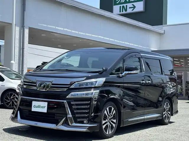 トヨタ ヴェルファイア Z Gエディション 熊本県 2018(平30)年 7.1万km ブラック ワンオーナー/モデリスタフルエアロ/モデリスタマフラー/モデリスタミラーガーニッシュ/モデリスタバックドアガーニッシュ/純正ディーラーナビ(NSZT-Y66T)/【フルセグTV/CD/DVD/Bluetooth】/バックカメラ/純正フリップダウンモニター(V12T-R66C)/両側パワースライドドア/衝突被害軽減システム/レーンキープアシスト/レーダークルーズコントロール/コーナーセンサー/合皮シート/前席パワーシート（D席メモリ付き）/前席シートヒーター/前席エアーシート/２列目オットマン/ハンドルヒーター/パワーバックドア/純正18インチアルミホイル/オートLEDライト/オートマチックハイビーム/ビルトインETC/純正フロアマット/横滑り防止装置/盗難防止装置/取扱説明書/保証書