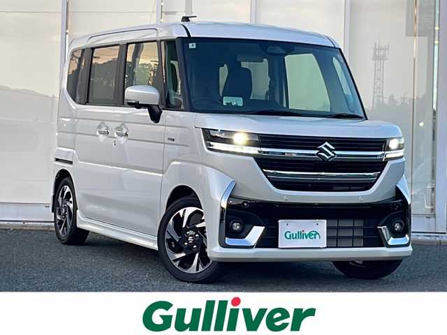スズキ スペーシア カスタム HYBRID XS 福岡県 2025(令7)年 0.1万km ピュアホワイトP 純正9インチナビ/　（AppleCarPlay/FM/AM/フルセグ/Bluetooth)/全方位カメラ/HUD/ステアリングヒーター/ヘッドライトレベライザー/両側パワースライドドア/レーダークルーズコントロール/革巻きステアリング/ディーラーOPフロアマット/ディーラーOPドアハンドルプロテクター/シートヒーター/横滑り防止装置/コーナーセンサー/レーンキープアシスト/衝突軽減システム/オートライト/LEDライト/純正ホイール/電格ミラー