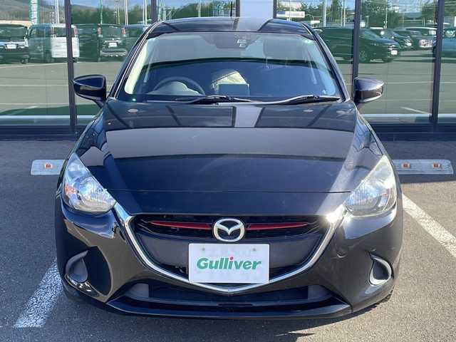 マツダ デミオ XD 道東・釧路十勝 2015(平27)年 4.8万km ジェットブラックマイカ ・４WD/・純正SDメモリナビ/（フルセグ FFM AM BT CD DVD)/・バックカメラ/・MT付きAT/・ヘッドライトレベライザー/・ドアバイザー/・電動格納ミラー/・ウィンカーミラー/・横すべり防止機能/・ステアリングスイッチ/・夏タイヤ積込/（185/65/R15　2015年製造）