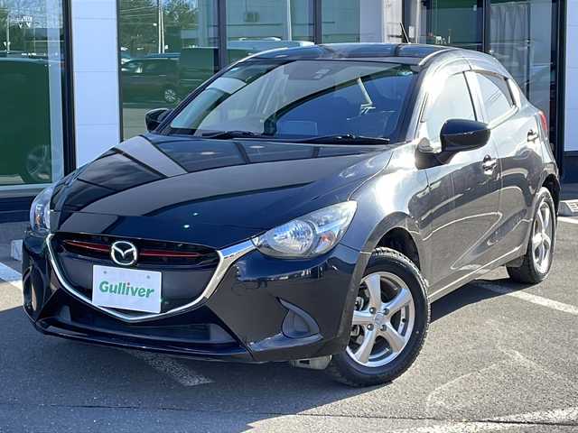 マツダ デミオ XD 道東・釧路十勝 2015(平27)年 4.8万km ジェットブラックマイカ ・４WD/・純正SDメモリナビ/（フルセグ FFM AM BT CD DVD)/・バックカメラ/・MT付きAT/・ヘッドライトレベライザー/・ドアバイザー/・電動格納ミラー/・ウィンカーミラー/・横すべり防止機能/・ステアリングスイッチ/・夏タイヤ積込/（185/65/R15　2015年製造）